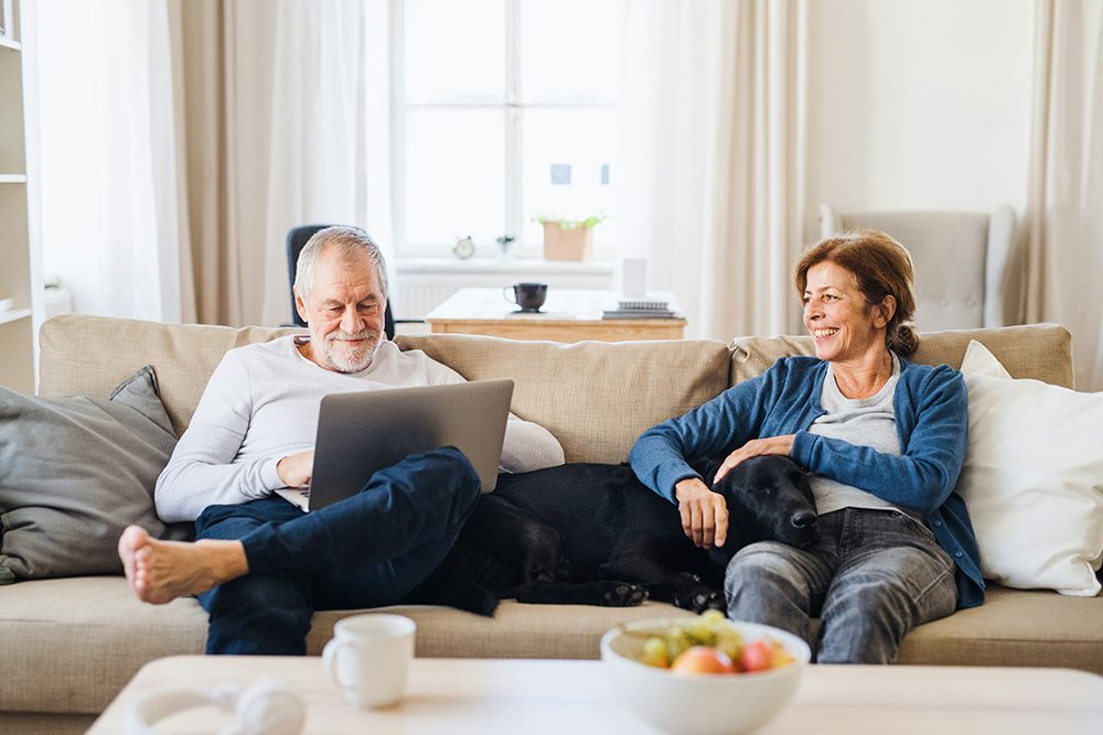 couple on couch with dog