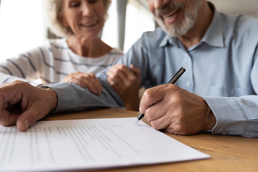 couple signing documents